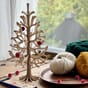 Lovi-Sprue-30cm-with-minibaubles-on-old-table-with-yarns-Ps.jpg